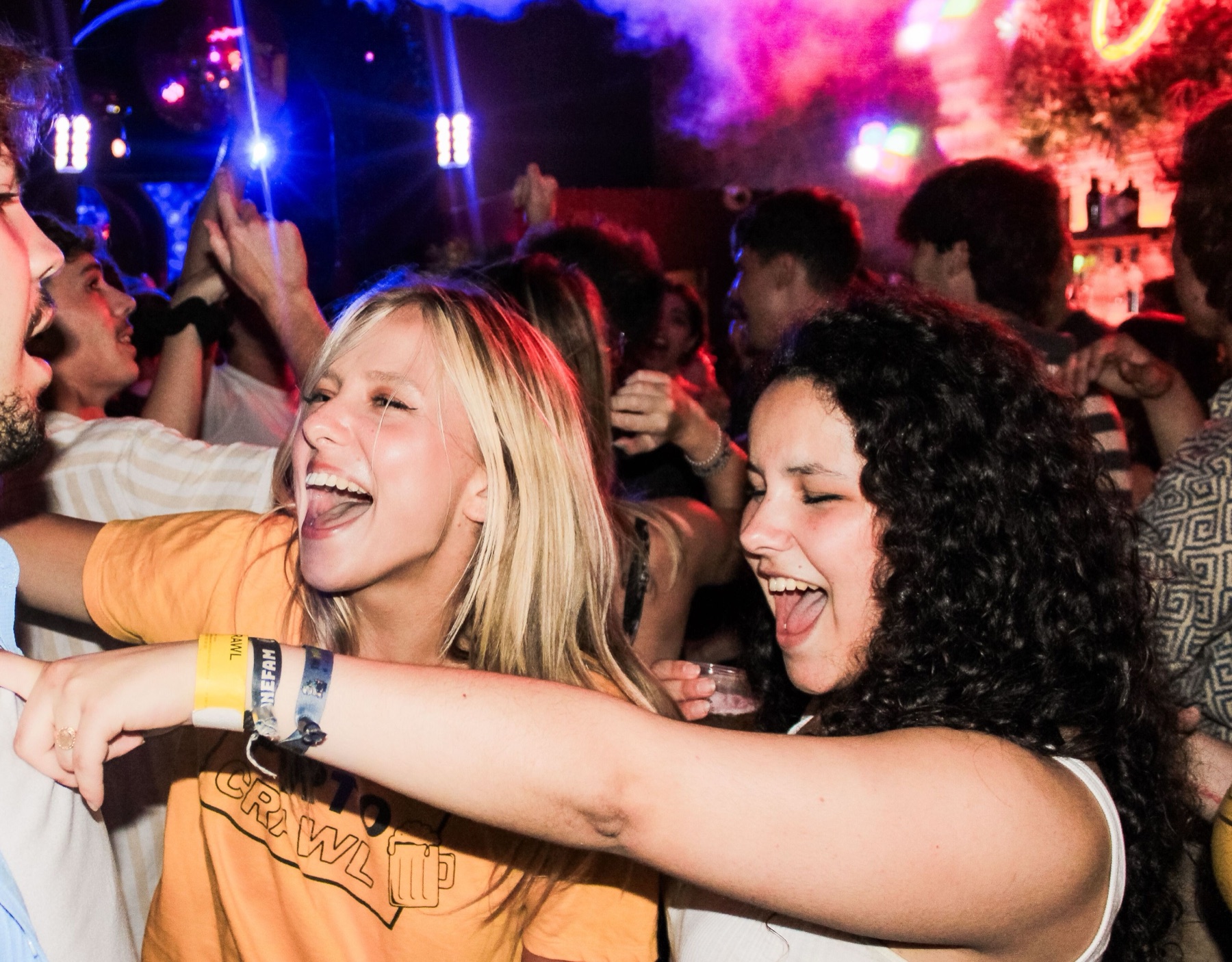 Friends dancing together at a Porto club