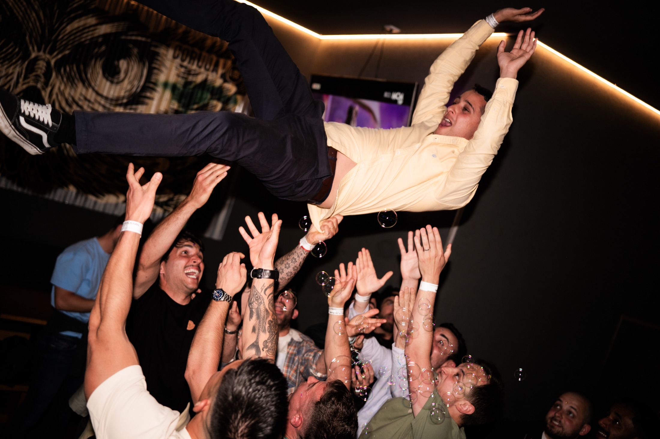 Private group crowd-surfing together during a Porto Crawl celebration